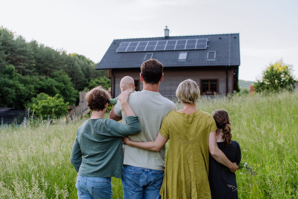 Budgi - rear view of family near their house with solar pa 2023 11 27 04 59 50 utc